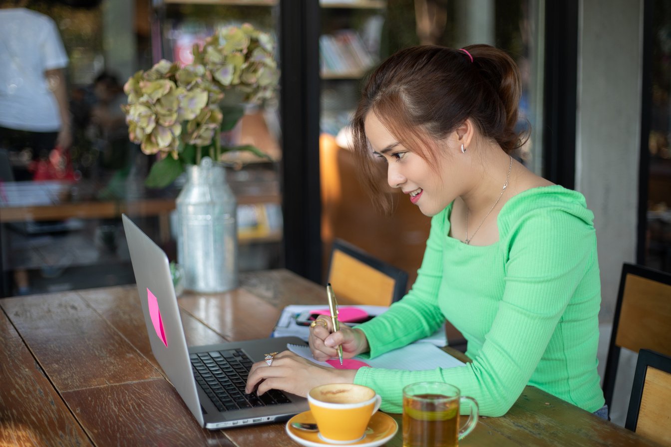 A Female Freelancer Working at a Cafe